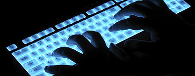 Hands over luminous keyboard (iStockphoto)