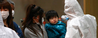 A child is screened for radiation exposure at a testing center Tuesday, March 15, 2011, in Koriyama city, Fukushima Prefecture, Japan, after a nuclear power plant on the coast of the prefecture was damaged by Friday's earthquake. (AP Photo/Wally Santana)