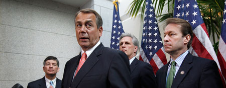 House Speaker John Boehner of Ohio, second from left, briefs reporters after lawmakers from both political parties came together on an 11th-hour deal to keep the government from shutting down, Friday, Dec. 16, 2011, on Capitol Hill in Washington. (AP Photo/J. Scott Applewhite)