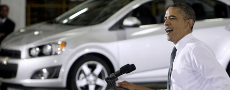 In this Oct. 14, 2011 file photo, President Barack Obama speaks at the General Motors Orion assembly plant in Orion Township, Mich. In the background is a Chevrolet Sonic. (AP Photo/Carlos Osorio, File)
