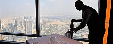 Bar captain, Solomon from Kenya, places a bottle of champagne at 'At.mosphere.' (AP/Kamran Jebreili)
