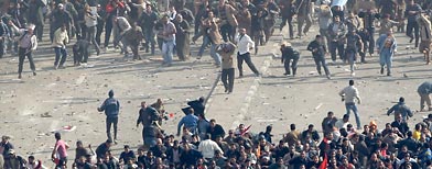 Pro-government demonstrators, below, and anti-government demonstrators, above, clash in Tahrir Square. (AP/Ben Curtis)