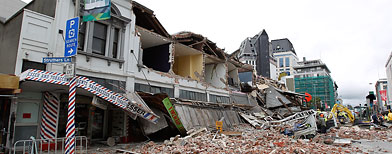 Collapsed buildings and debris along Manchester Street on February 22, 2011 in Christchurch, New Zealand.  (Photo by Martin Hunter/Getty Images)