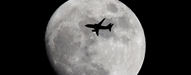 A plane flies across the moon (Dan Kitwood/Getty Images)