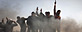 Libyan rebels celebrate on top of burning cars after Libyan leader Moammar Gadhafi's forces were pushed back from Benghazi, eastern Libya, Saturday, March 19, 2011.