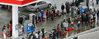 People queue up in front of a gas station in Mito, north of Tokyo. (AP Photo/Kyodo News)