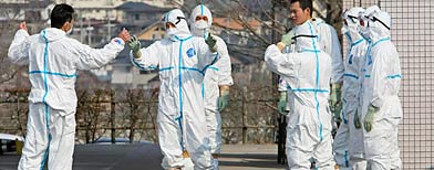 Japan Self Defense Force members prepare to transfer worker exposed to radiation at Fukushima Daiichi nuclear plant (Yomiuri Shimbun/Reuters)