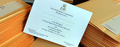 A member of staff at Buckingham Palace inserts the invitations into envelopes, to the wedding of Prince William and Miss Catherine Middleton, before posting them to the guests who will be present on April 29 at Westminster Abbey. (Press Association)