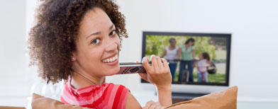 Woman with remote (Thinkstock)
