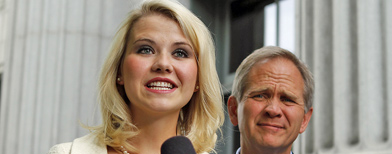 Elizabeth Smart and her father Ed Smart talk to the media out front of the Frank E. Moss Federal Courthouse on Wednesday, May 25, 2011, in Salt Lake City. Smart's assailant, Brian David Mitchell, was sentenced to life in prison for kidnapping and raping her while holding her captive for months. (AP Photo/Jim Urquhart)