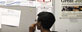 A job seeker looks at a bulletin at the Texas Workforce Commission's Workforce Solutions of Greater Dallas job resource center in Richardson, Texas Tuesday, July 5, 2011. (AP Photo/LM Otero)