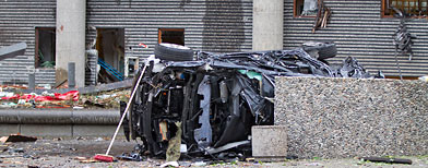 The wreckage of a car lies outside a building in the centre of Oslo, Friday July 22, 2011, following an explosion that tore open several buildings including the prime minister's office. (AP Photo / Thomas Winje, Scanpix Norway)