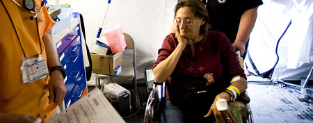 An unidentified woman is wheeled out of the emergency tent to be taken to hospital, at the Remote Area Medical (RAM) clinic on July 22, 2007 at the Wise County Fairground in Wise, Virginia.  (Photo by Suzy Allman/Getty Images)
