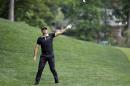 Jason Day, of Australia, points in the direction of his shot from the rough on the ninth hole during the final round of the Memorial golf tournament, Sunday, June 5, 2016, in Dublin, Ohio. (AP Photo/Darron Cummings)