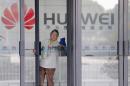 File photo shows a cleaner wiping the glass door of a Huawei office in Wuhan
