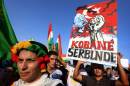 Iraqi Kurdish supporters of the Kurdistan Workers Party demonstrate against the threat imposed by the Islamic State group jihadists against the Syrian Kurdish town of Kobane, outside the UN office in Arbil, October 8, 2014