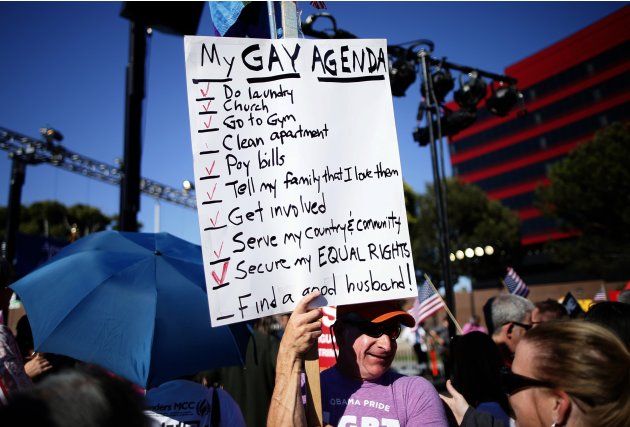 A man holds a sign at a rally in West Hollywood, after the United States Supreme Court ruled on California's Proposition 8 and the federal DOMA