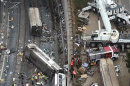 This aerial image taken from video shows a general view of the site of a train accident in Santiago de Compostela, Spain, on Thursday July 25, 2013. The death toll in a passenger train crash in northwestern Spain rose to 77 on Thursday after the train jumped the tracks on a curvy stretch just before arriving in the northwestern shrine city of Santiago de Compostela, a judicial official said. (AP Photo)