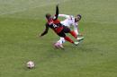 Lyon's Alexandre Lacazette, right, challenges for the ball with Guingamp's Balssama Sankoh, left, during their French League One soccer match in Lyon, central France, Sunday, Nov. 9, 2014. (AP Photo/Laurent Cipriani)