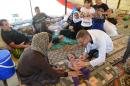 A doctor checks a Iraqi baby from the Yazidi community in a refugee camp near the Turkey-Iraq border at Silopi in Sirnak on August 14, 2014