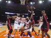 Heat's Bosh leaps to block Knicks' Brewer as he looks to shoot in the first quarter of their NBA basketball game in New York