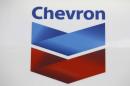 FILE - In this July 25, 2011, file photo, a Chevron logo appears at a gas station in Miami. The American lawyer who advised Ecuadorean residents as they won a $9 billion judgment against Chevron Corp. says Tuesday, March 4, 2014 it's appalling that a New York judge found that the award resulted from fraud. (AP Photo/Lynne Sladky, File)