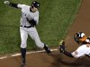 New York Yankees' Ichiro Suzuki, left, of Japan, runs past Baltimore Orioles catcher Matt Wieters to score a run on a double by Robinson Cano in the first inning of Game 2 of the American League division baseball series on Monday, Oct. 8, 2012, in Baltimore. (AP Photo/Patrick Semansky)