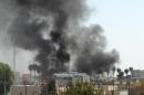 Smoke rises from buildings in the northern Iraqi city of Kirkuk following a car bomb attack on October 2, 2013