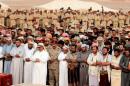 Yemeni army officers and troops perform prayers during the funeral procession of troops killed by Saudi-led air strike on an army base that was hit in error, in al-Abr on the border with Saudi Arabia