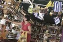 A woman buys products in a grocery market in central Athens