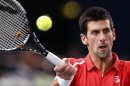Djokovic of Serbia returns the ball to Querrey of the US during the Paris Masters tennis tournament in Paris