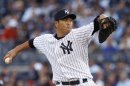 New York Yankees starting pitcher Hiroki Kuroda throws to the Detroit Tigers during the first inning of Game 2 of their MLB ALCS playoff baseball series in New York