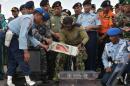 Indonesian officers move the Flight Data Recorder (C) of the AirAsia Flight QZ8501 into a suitable protective transportation case in Pangkalan Bun after it was retrieved from the Java Sea on January 12, 2015