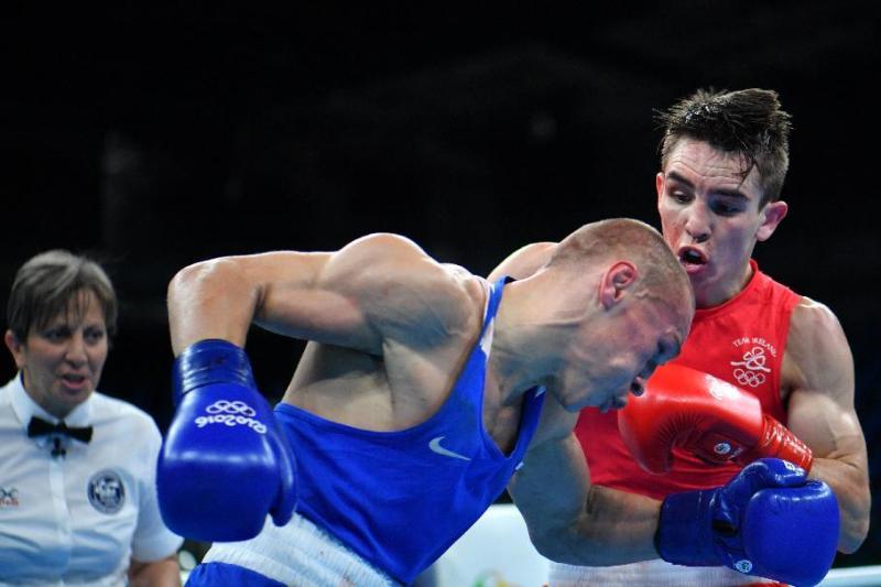 Vladimir Nikitin takes a blow from Michael Conlan in Rio on August 16, 2016 (AFP Photo/Yuri Cortez)