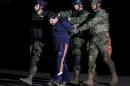 Recaptured drug lord Joaquin "El Chapo" Guzman is escorted by soldiers in Mexico Cityy