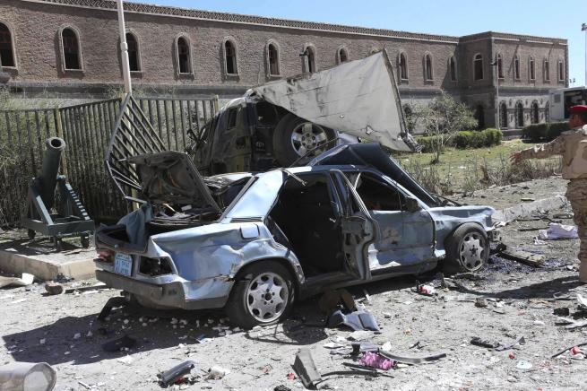 Damaged vehicles are seen at the scene of a suicide attack at the Defence Ministry compound in Sanaa