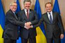Ukrainian President Petro Poroshenko (C) laughs with European Commission President Jean-Claude Junker (L) and EU Council President Donald Tusk as they shake hands at the EU Council in Brussels on March 17, 2016