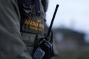 U.S. Border Patrol agent David Faatoalia wears a radio on his chest as he patrols along the international border between Mexico and the United States near San Diego