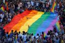 Gay rights activists carry a rainbow flag during protest at Tunel Square in Istanbul