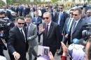 Turkish President Recep Tayyip Erdogan (C) greets supporters as he arrives for the inauguration of the Bayzid I Mosque (Yildrim Bayezid) at the Esenboga International Airport in Ankara, on June 23, 2016