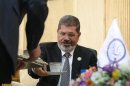 Egypt's President Mohamed Mursi is seen before his meeting with Iran's Executive Vice President Hamid Baghai at Mehrabad airport in Tehran