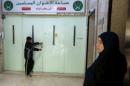 A boy stands near the main entrance of the Muslim Brotherhood's office in Amman