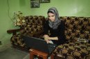 In this Sept. 27, 2012 photo, college student Shahad Abdul-Amir Abbas, 21, studies at her home in Baghdad. She lost her father in sectarian killings in 2005 and now volunteers to help orphans at her mother's orphanage in addition to attending the University of Medicine. (AP Photo/Karim Kadim)