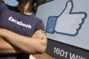 A Facebook worker waits for friends to arrive outside of Facebook headquarters in Menlo Park, Calif., Friday, Aug. 17, 2012. Facebook stock is trading at $19 and has lost half its market value since its May public offering. (AP Photo/Paul Sakuma)