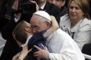Pope Francis hugs a child after celebrating his first Easter Mass in St. Peter's Square at the Vatican, Sunday, March 31, 2013. Pope Francis celebrated his first Easter Sunday Mass as pontiff in St. Peter's Square, packed by joyous pilgrims, tourists and Romans and bedecked by spring flowers.Wearing cream-colored vestments, Francis strode onto the esplanade in front of St. Peter's Basilica and took his place at an altar set up under a white canopy. (AP Photo/Gregorio Borgia)