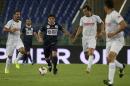 Diego Armando Maradona controls the ball as Diego Simeone, left, Gabriel Heinze, second right, and Ivan Zamorano watch him, during an inter-religious soccer match for peace, supported by Pope Francis to promote the dialogue and peace among different religions, at Rome's Olympic Stadium, Monday, Sept. 1, 2014. (AP Photo/Gregorio Borgia)