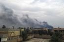 Smoke billows from the Iraqi city of Ramadi during clashes between security forces and anti-government gunmen, on December 30, 2013