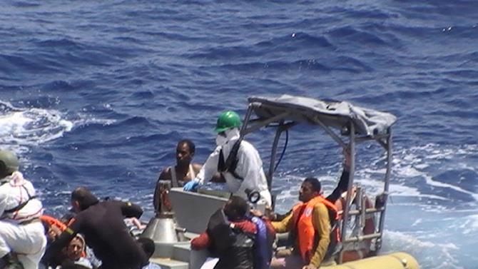 The Italian navy rescues survivors after a boat carrying over 600 migrants capsized in the Mediterranean off the Libyan coast on August 5, 2015