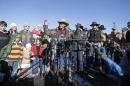LaVoy Finicum, center, a rancher from Arizona, speaks to reporters as his family looks on, left, during a news conference at Malheur National Wildlife Refuge Friday, Jan. 8, 2016, near Burns, Ore. Ammon Bundy, the leader of a small, armed group occupying a national wildlife refuge in Oregon says the activists have no immediate plans to leave. Bundy spoke to reporters Friday, a day after meeting with a local sheriff who asked the group to go. (AP Photo/Rick Bowmer)