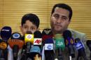 FILE--In this file photo taken on Thursday, July 15, 2010, Shahram Amiri, an Iranian nuclear scientist attends a news briefing while holding his son Amir Hossein as he arrives at the Imam Khomeini airport just outside Tehran, Iran, after returning from the United States. Amiri, who was caught up in a real-life U.S. spy mystery and later returned to his homeland and disappeared, has reportedly been executed under similarly mysterious circumstances. Amiri was reportedly hanged this week and family members held a memorial service for him in the Iranian city of in Kermanshah, 500 kilometers (310 miles) southwest of Tehran. State media in Iran, which has been silent about Amiri's case for years, has not reported his death. (AP Photo/Vahid Salemi, File)